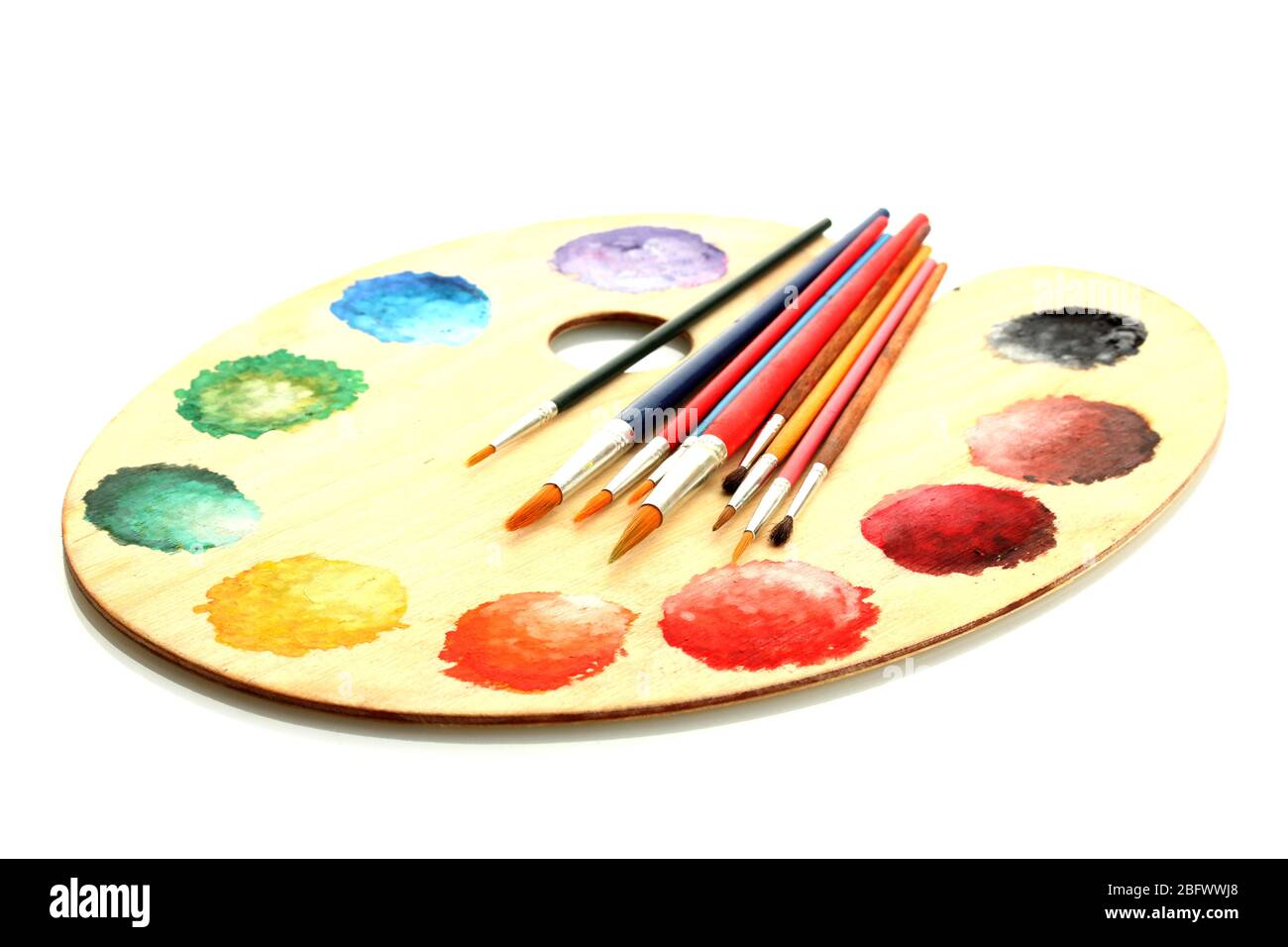 wooden art palette with paint and brushes isolated on white Stock Photo ...
