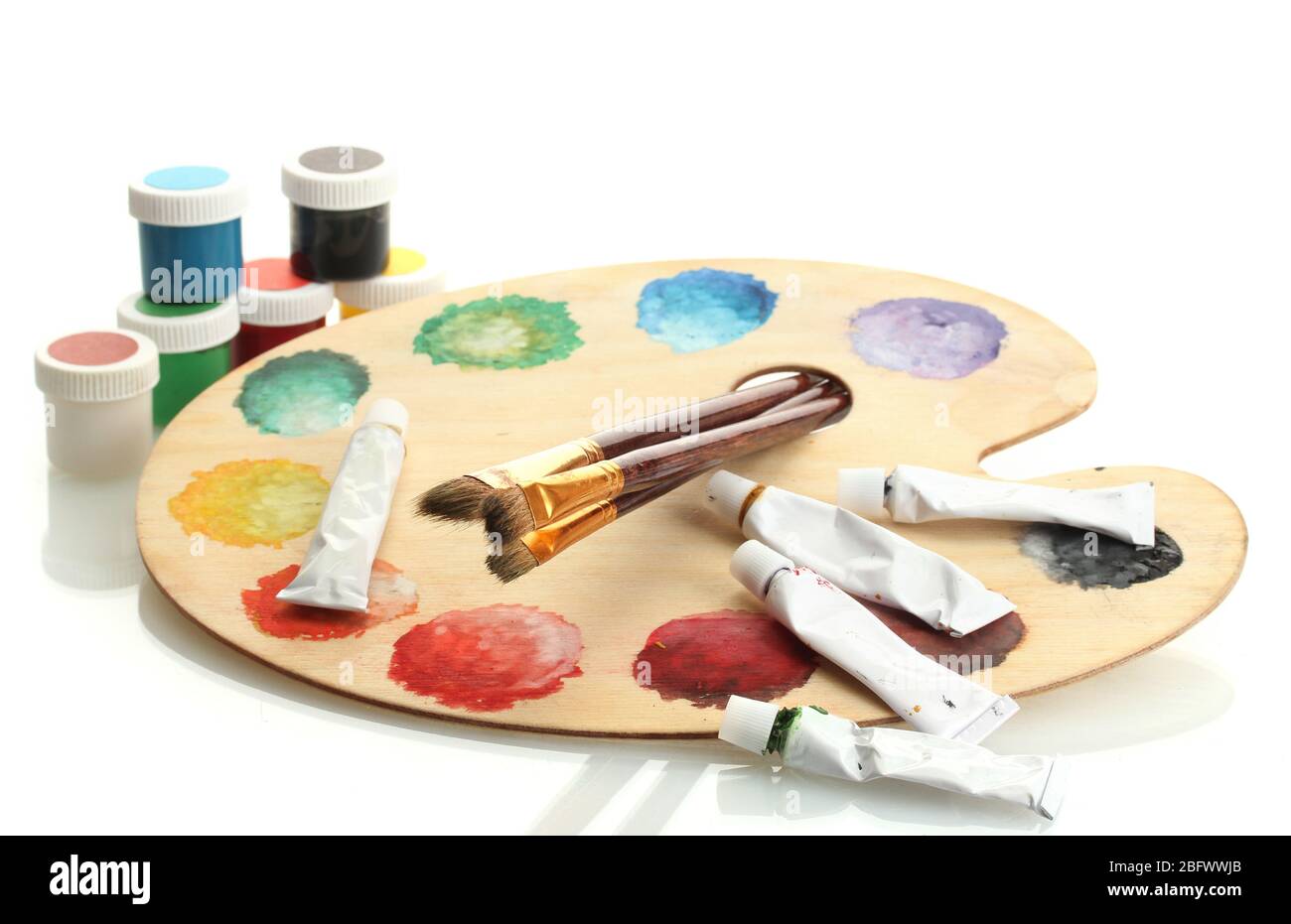 wooden art palette with paint and brushes isolated on white Stock Photo ...