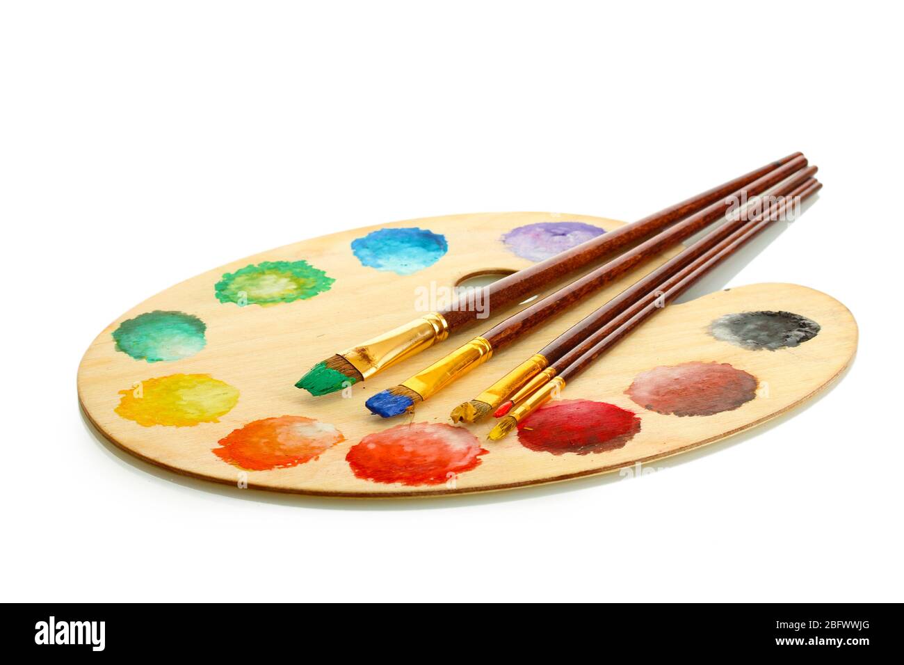 wooden art palette with paint and brushes isolated on white Stock Photo ...