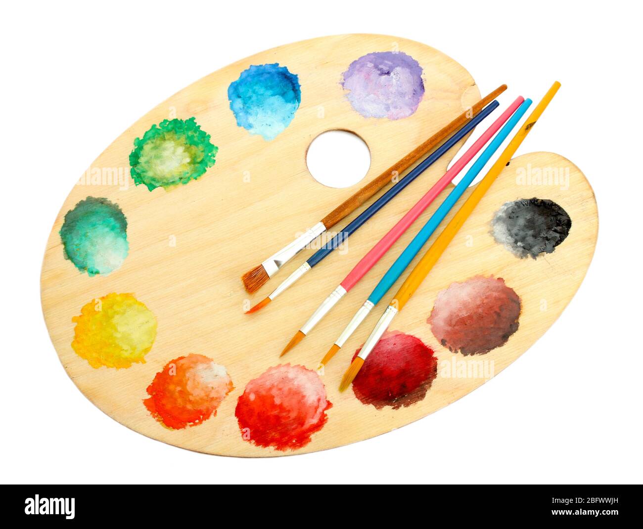 wooden art palette with paint and brushes isolated on white Stock Photo ...