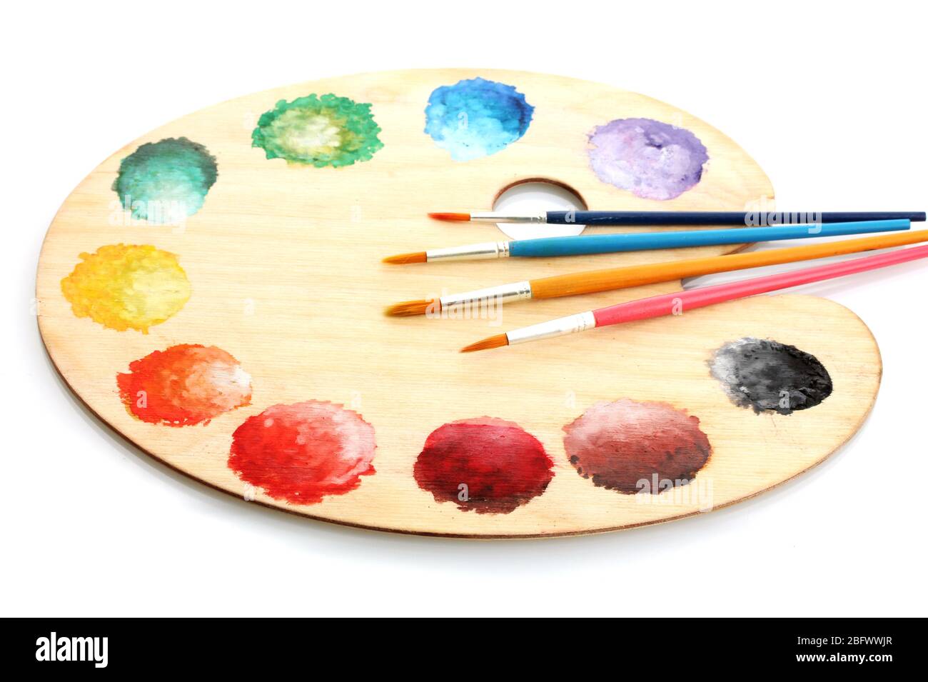 wooden art palette with paint and brushes isolated on white Stock Photo ...