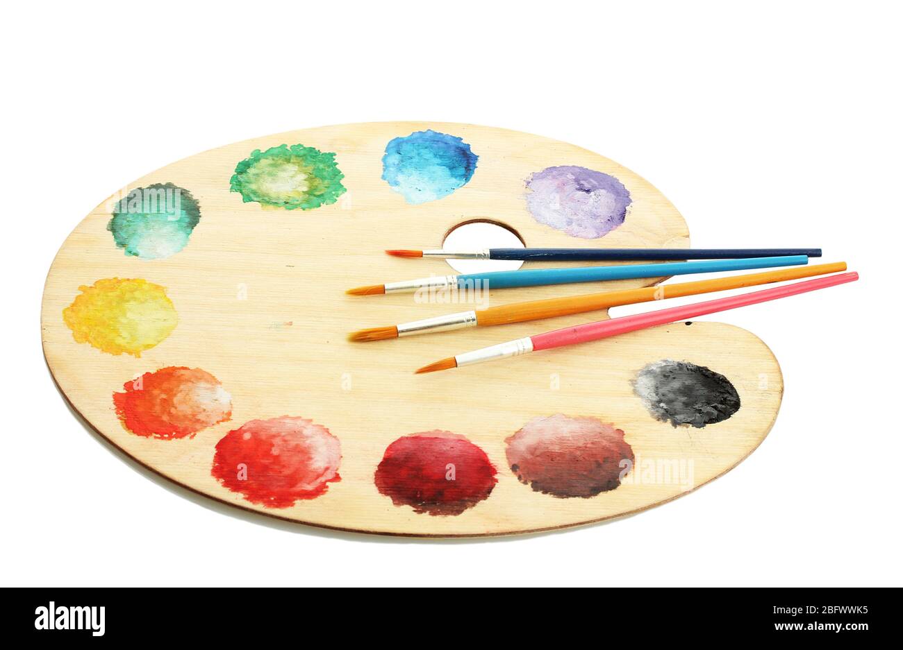 wooden art palette with paint and brushes isolated on white Stock Photo ...