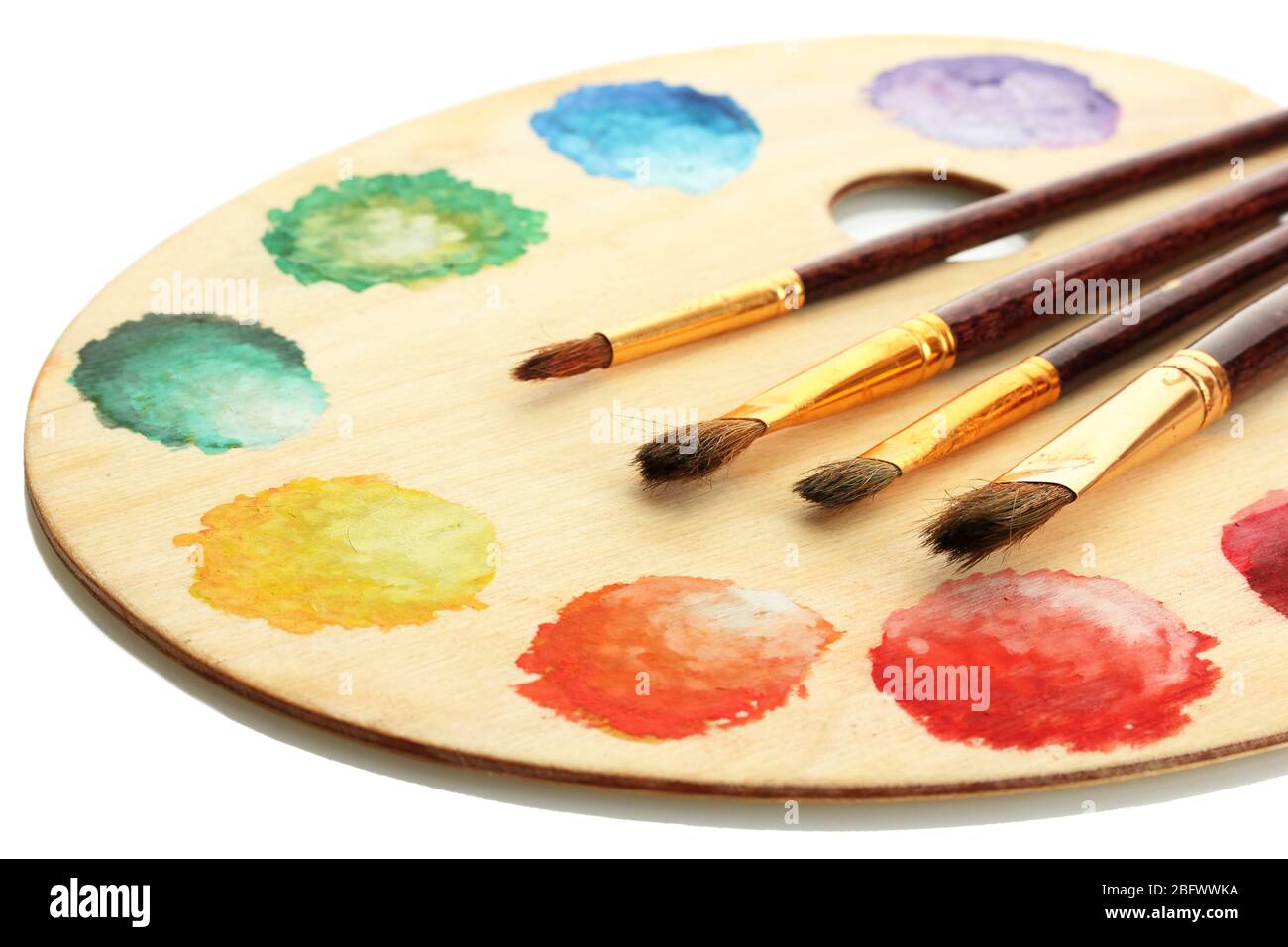 wooden art palette with paint and brushes isolated on white Stock Photo ...