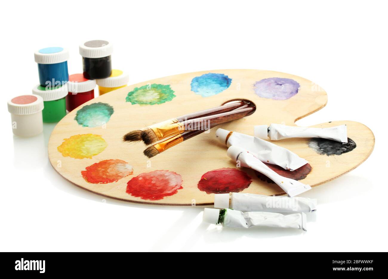 wooden art palette with paint and brushes isolated on white Stock Photo ...