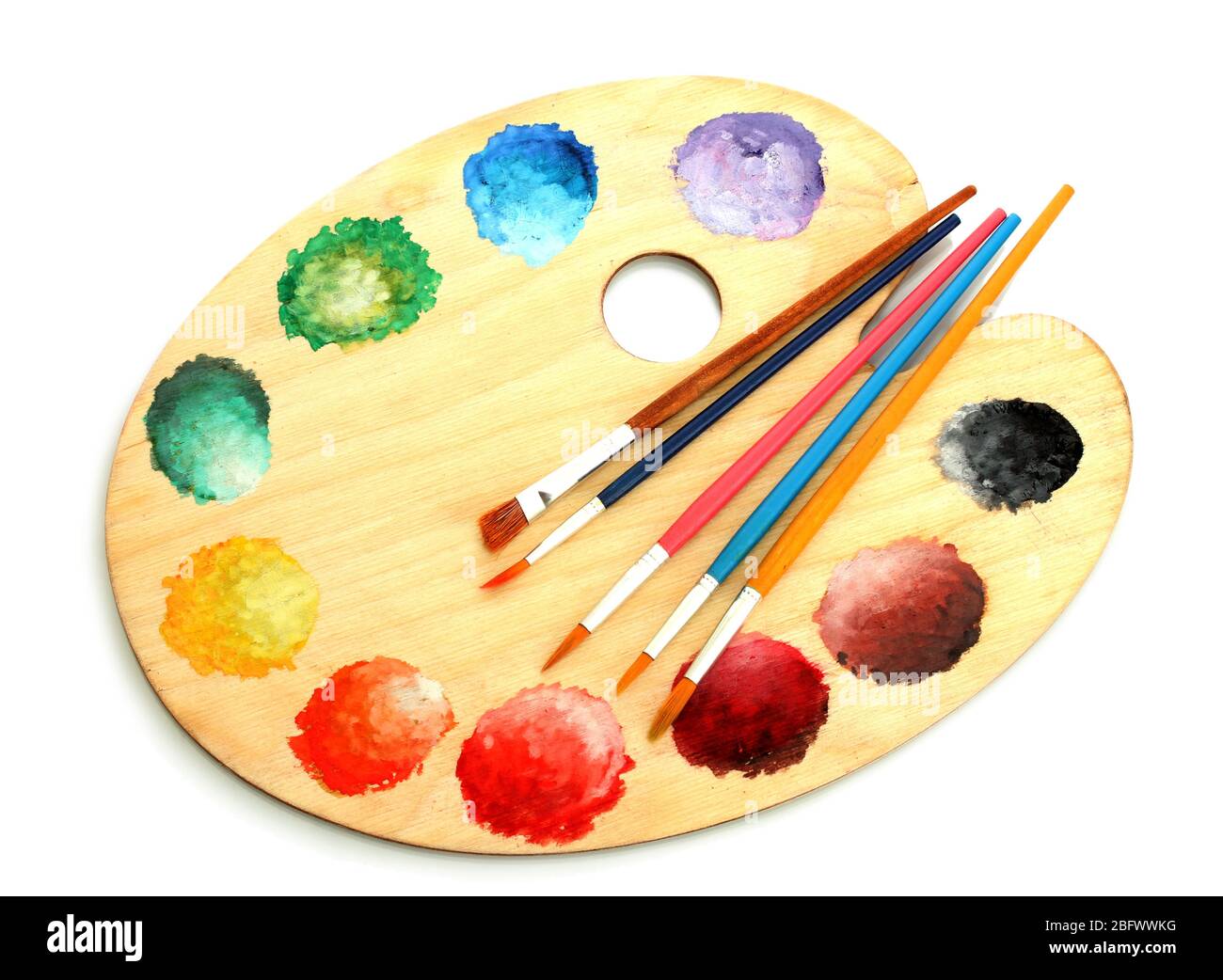 wooden art palette with paint and brushes isolated on white Stock Photo ...
