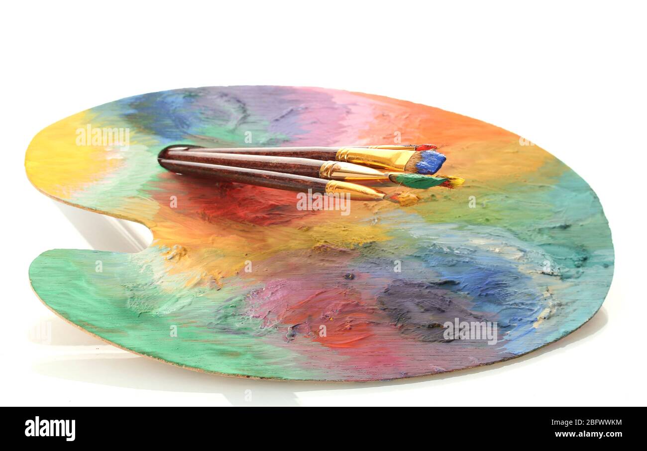 wooden art palette with paint and brushes isolated on white Stock Photo ...