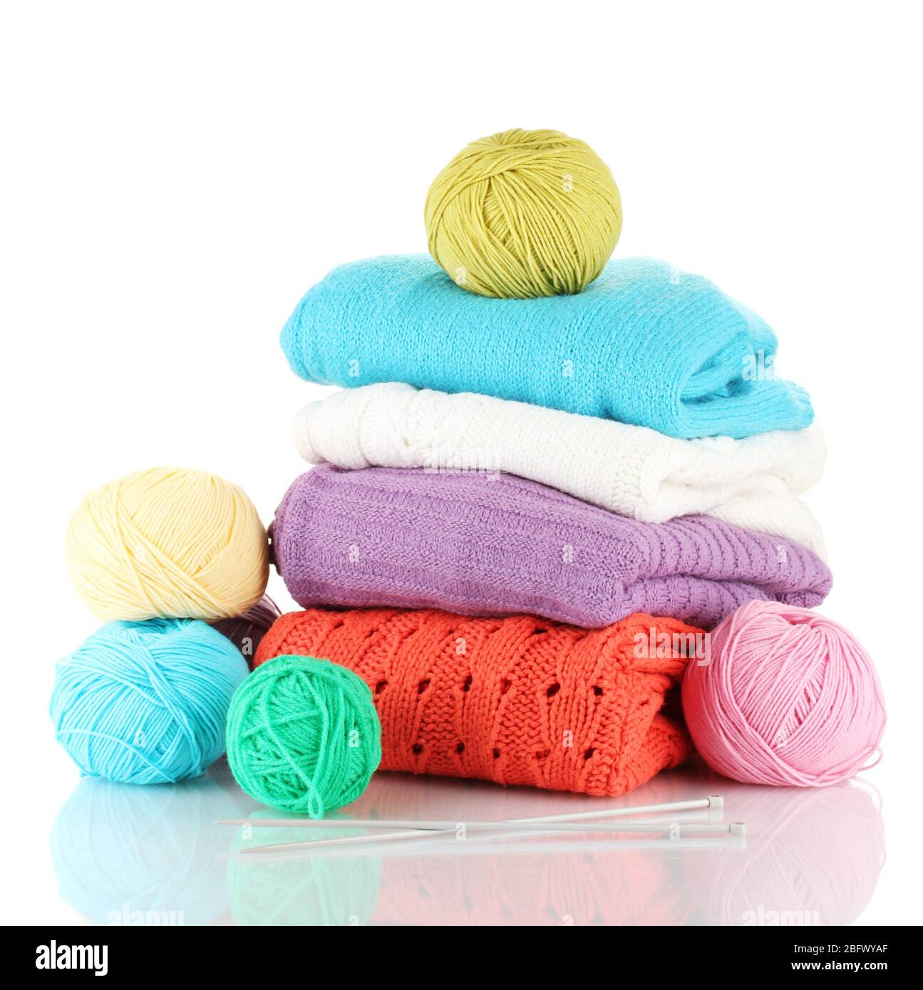 Sweaters and balls of wool isolated on white Stock Photo Alamy