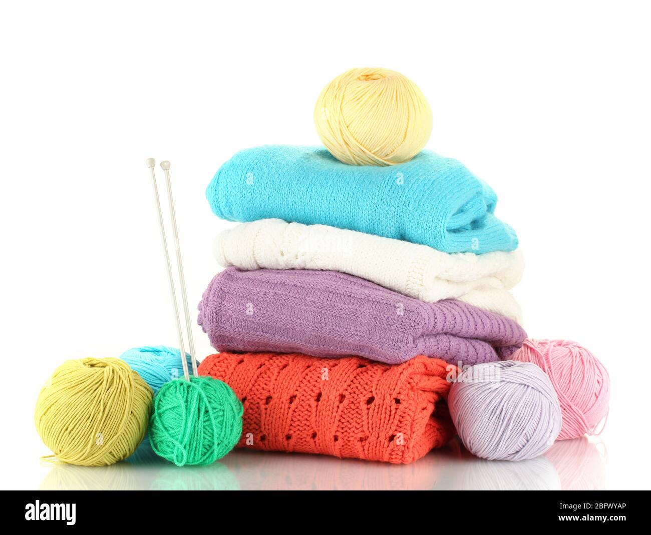 Sweaters and balls of wool isolated on white Stock Photo Alamy
