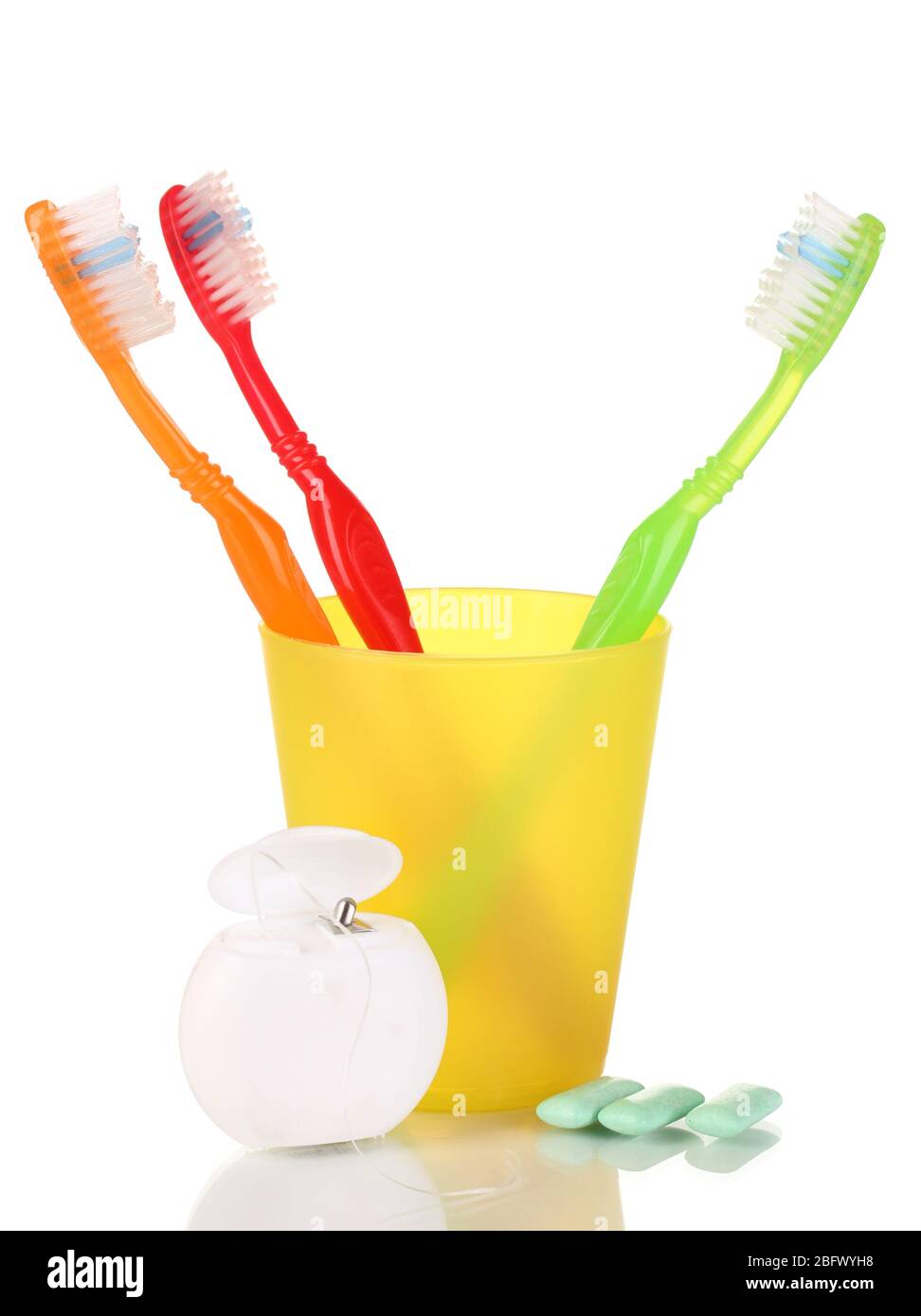 Toothbrushes, chewing gum and dental floss isolated on white Stock