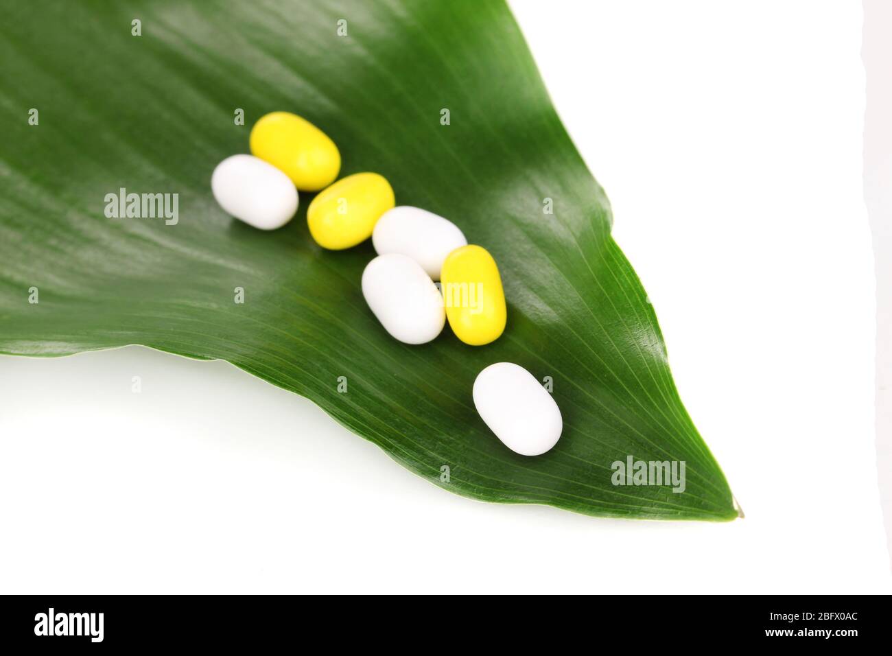 tablets on green leaf isolated on white Stock Photo