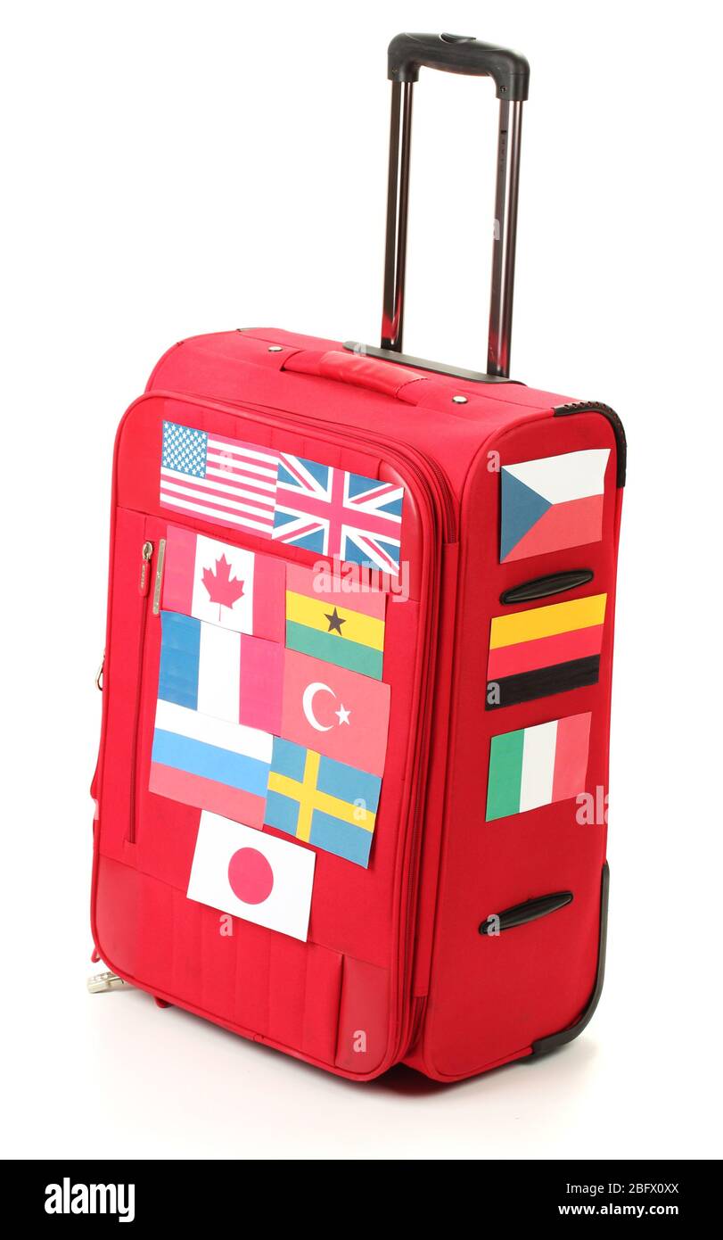 red suitcase with many stickers with flags of different countries isolated on white Stock Photo