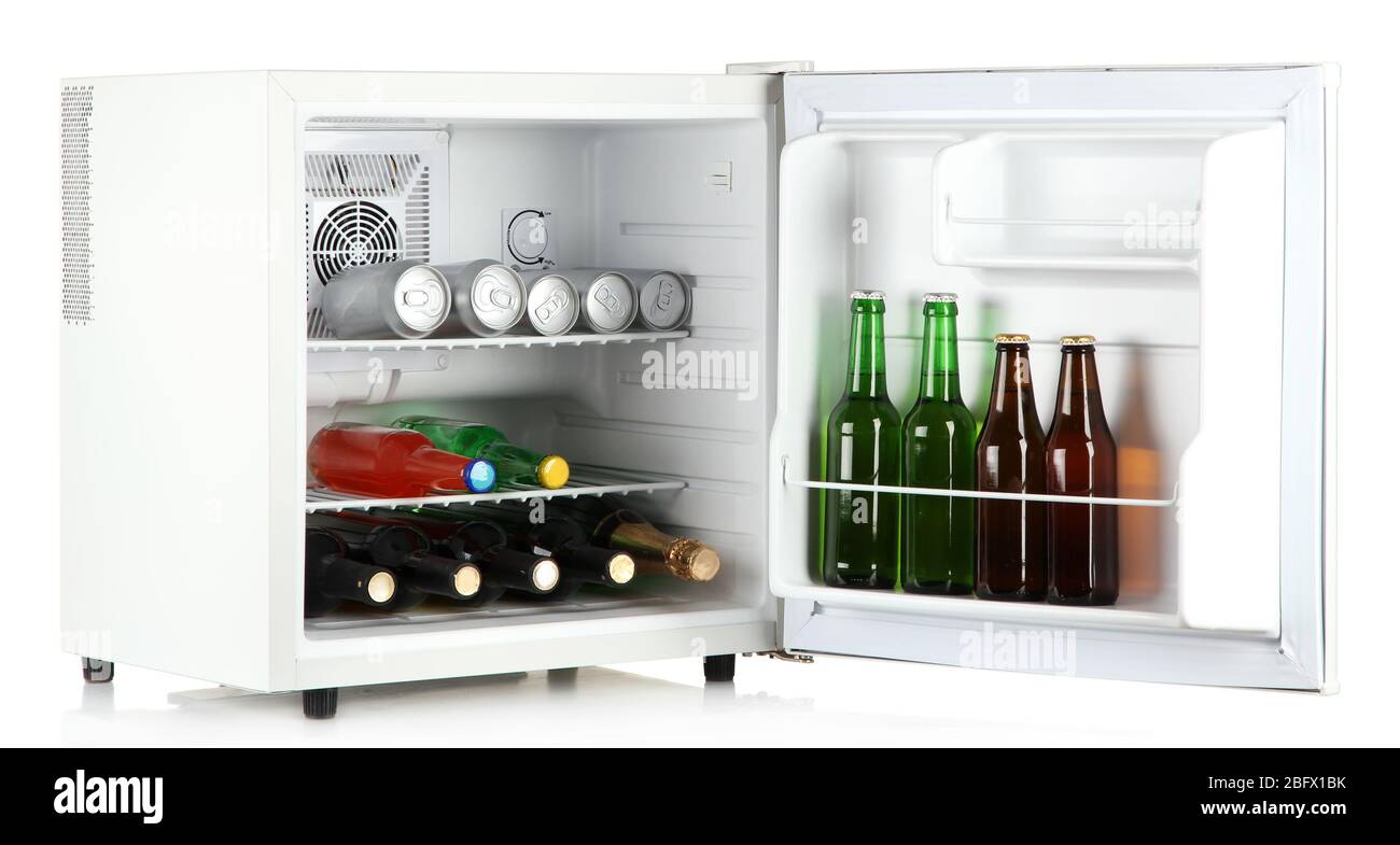 Mini fridge full of bottles of alcoholic beverages isolated on white Stock Photo