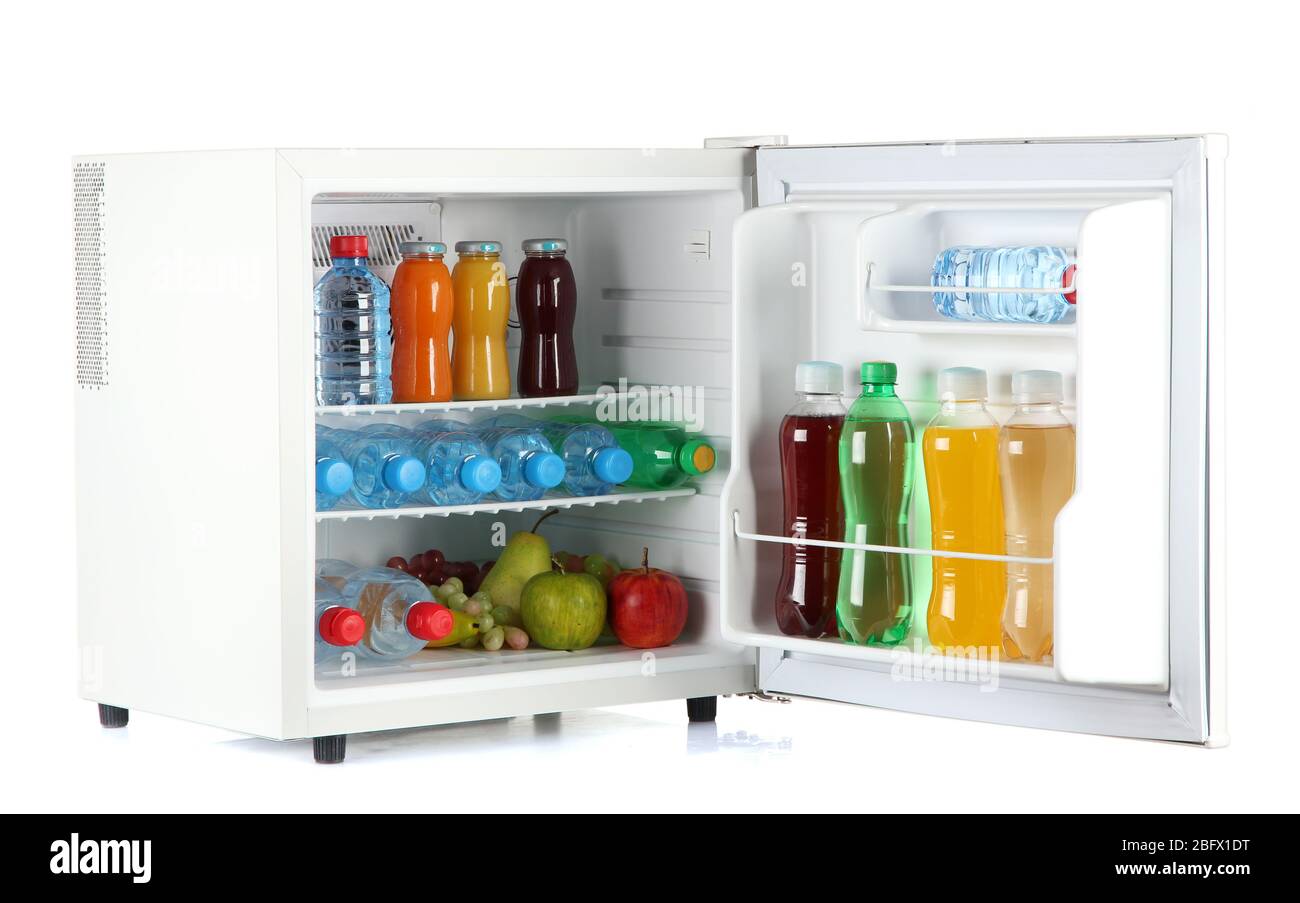 mini fridge full of bottles of juice, soda and fruit isolated on white