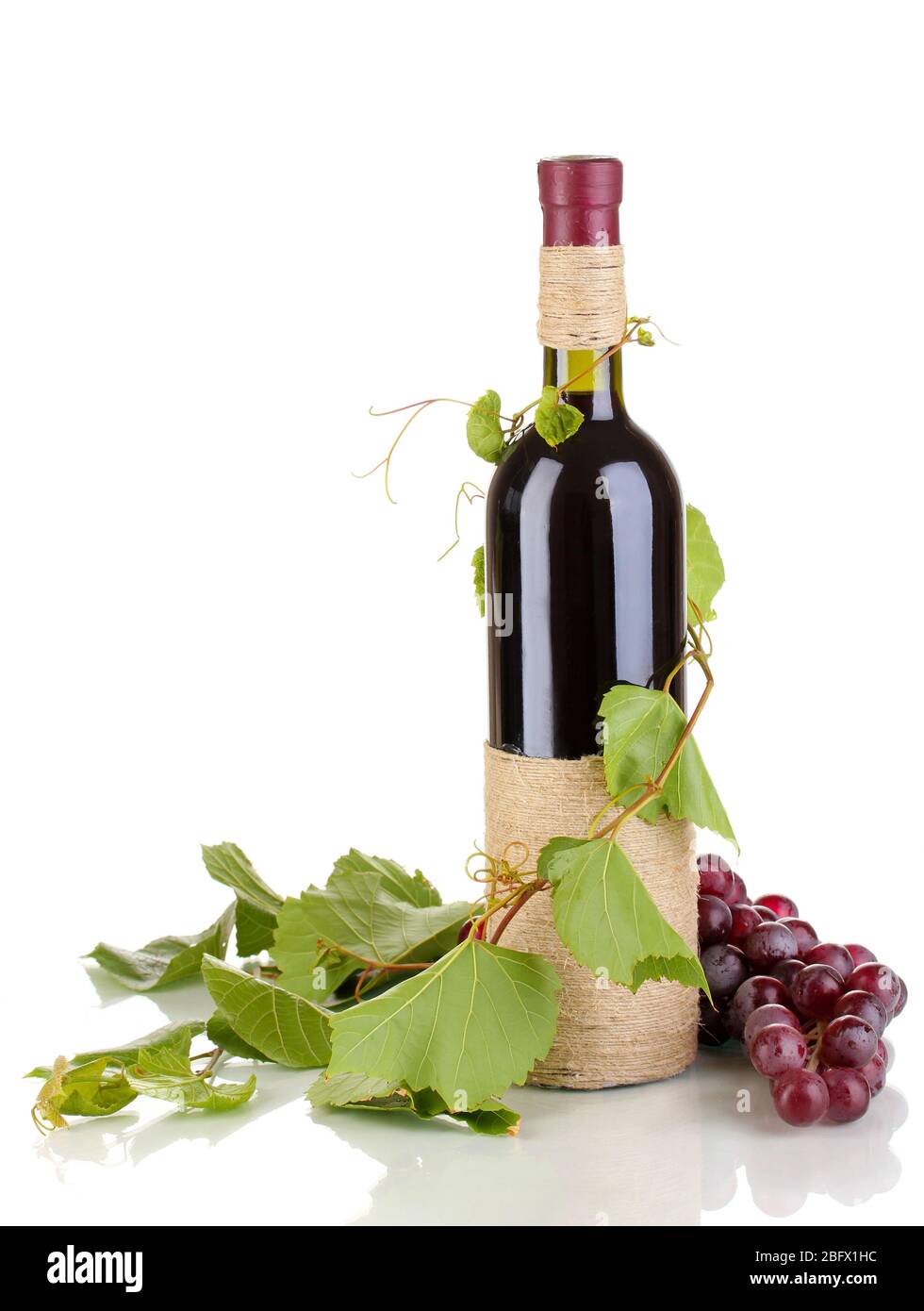 bottle of wine with grape leaves isolated on white Stock Photo - Alamy