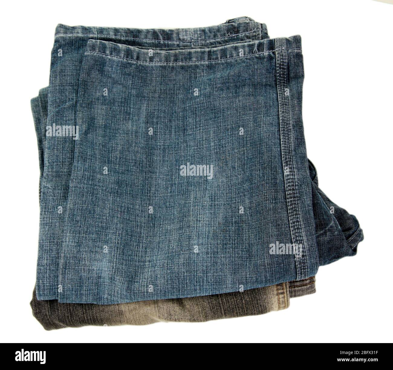 Stack fashion jeans close-up isolated on white Stock Photo
