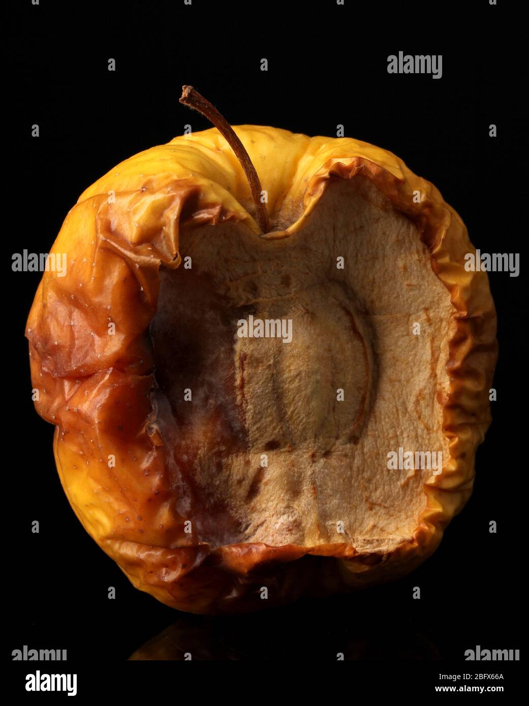 yellow moldy apple as concept of skin problems, isolated on black Stock ...