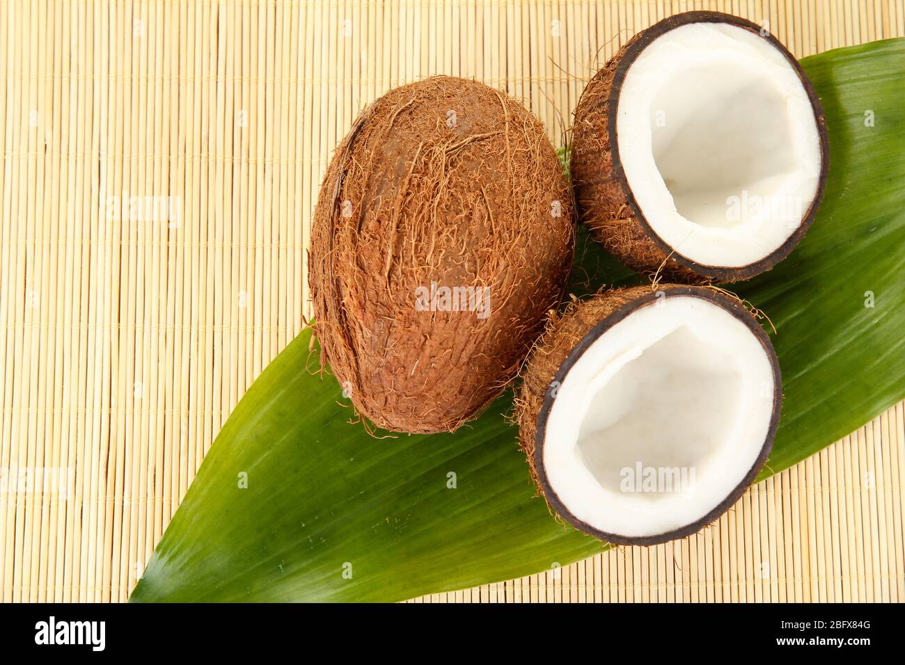 coconuts on a beige wicker mst close-up Stock Photo
