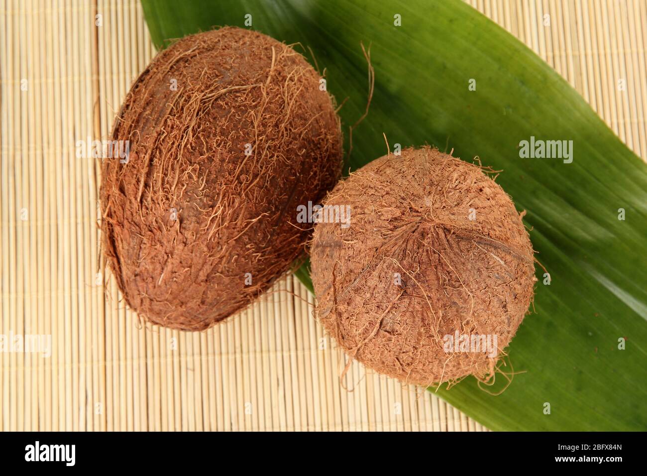 coconuts on a beige wicker mst close-up Stock Photo
