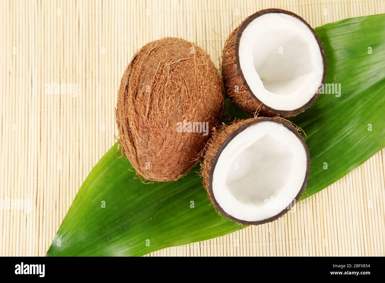 coconuts on a beige wicker mst close-up Stock Photo