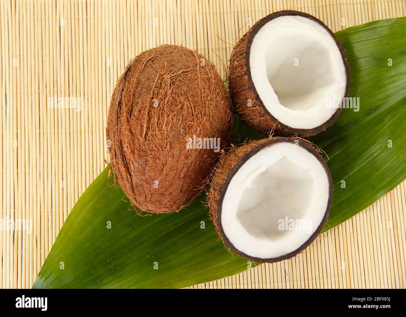 coconuts on a beige wicker mst close-up Stock Photo