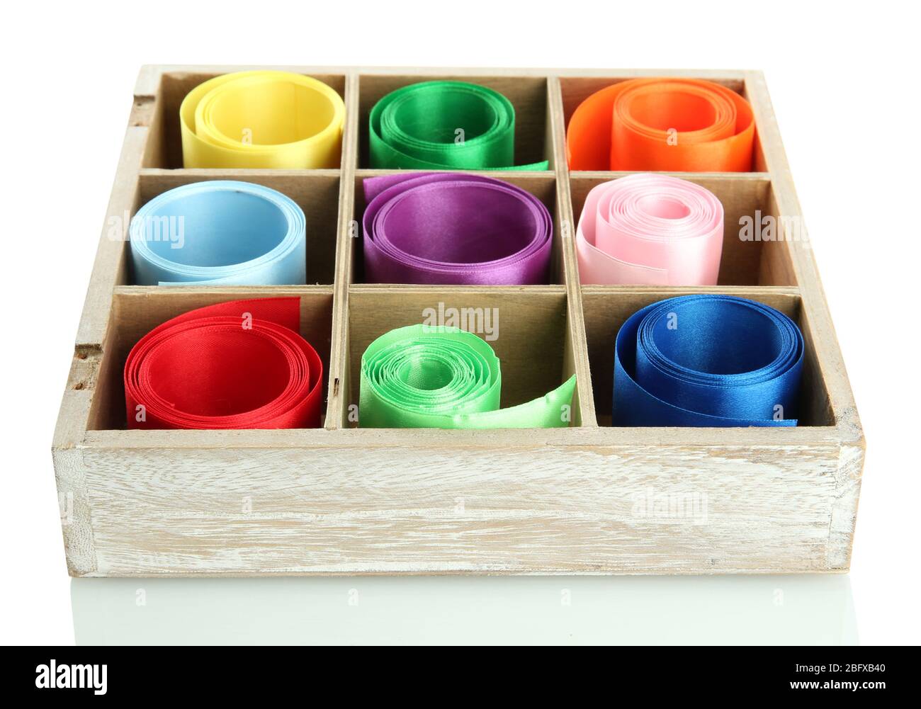 bright silk ribbons in wooden box, isolated on white Stock Photo - Alamy