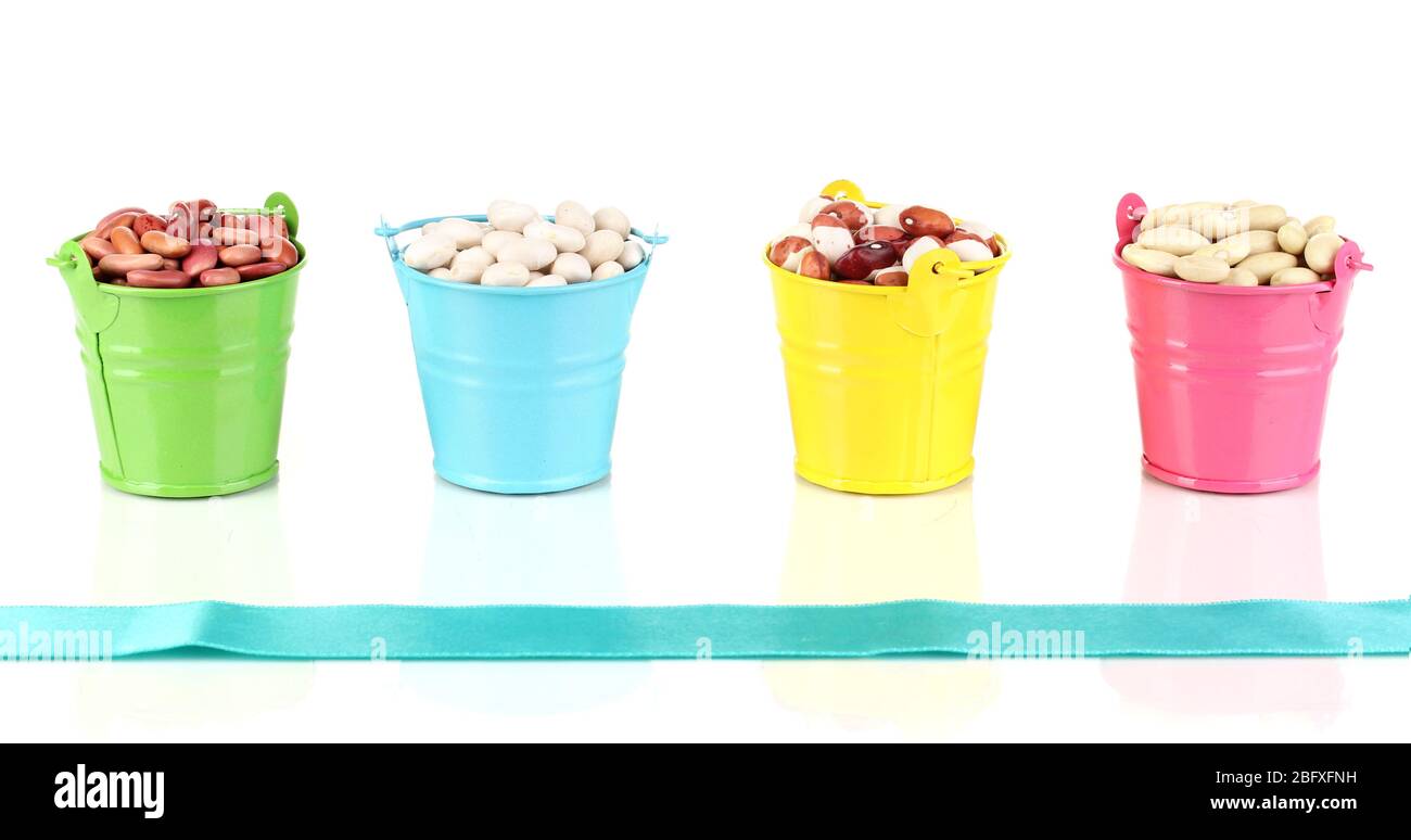 Different types of beans in colored buckets isolated on white Stock