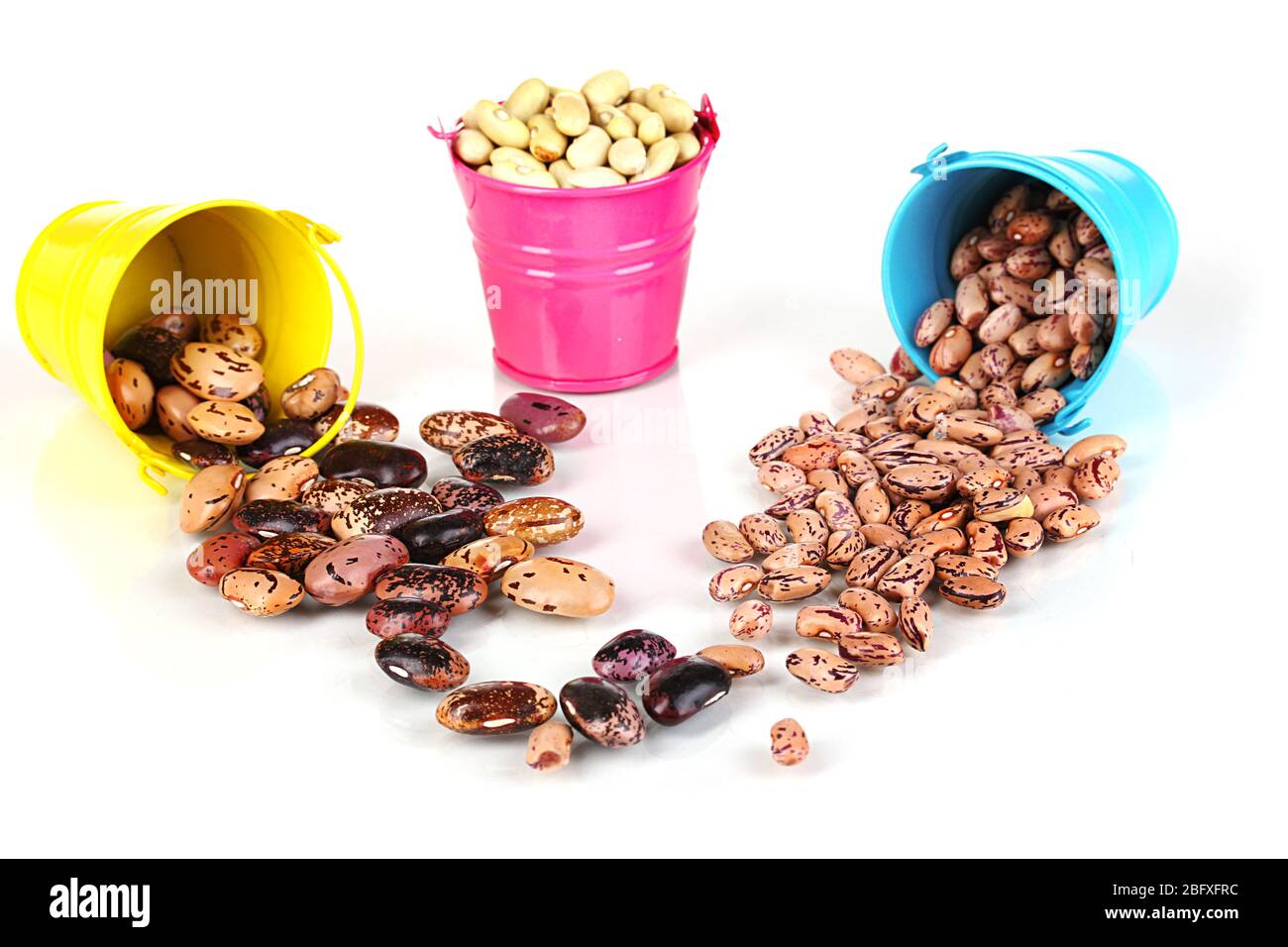 Different types of beans in colored buckets isolated on white Stock