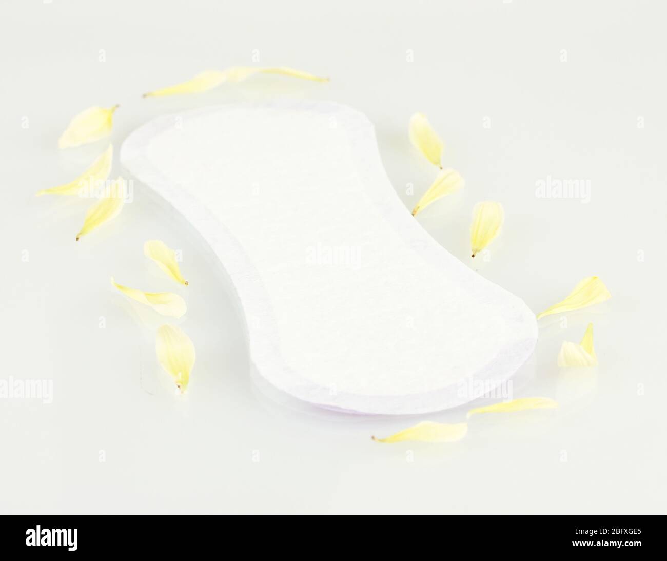 Daily panty liner and yellow petals isolated on white Stock Photo Alamy