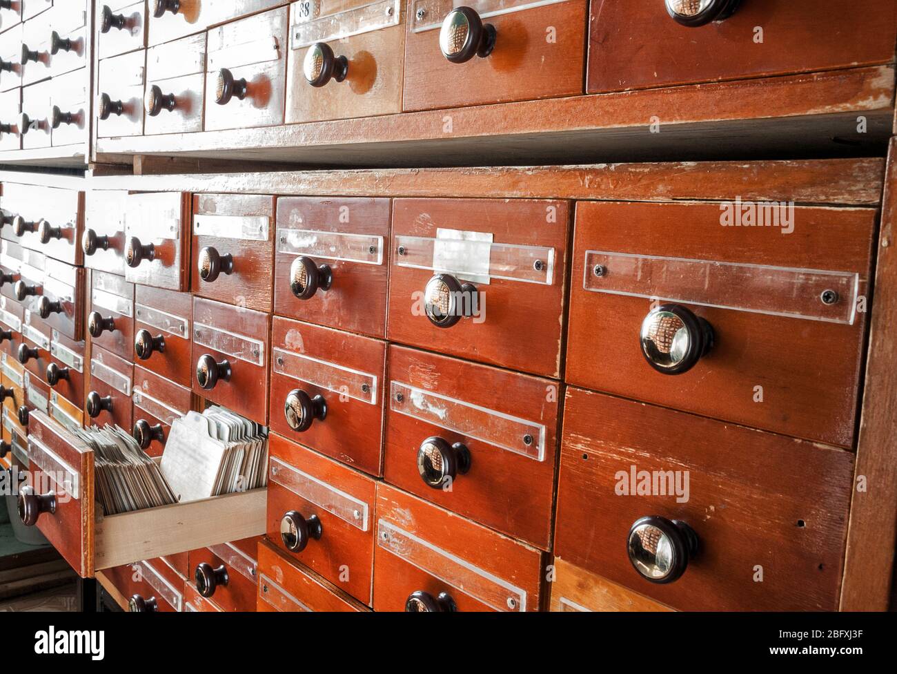 Old directory with many wooden index drawers. Vintage file catalog box