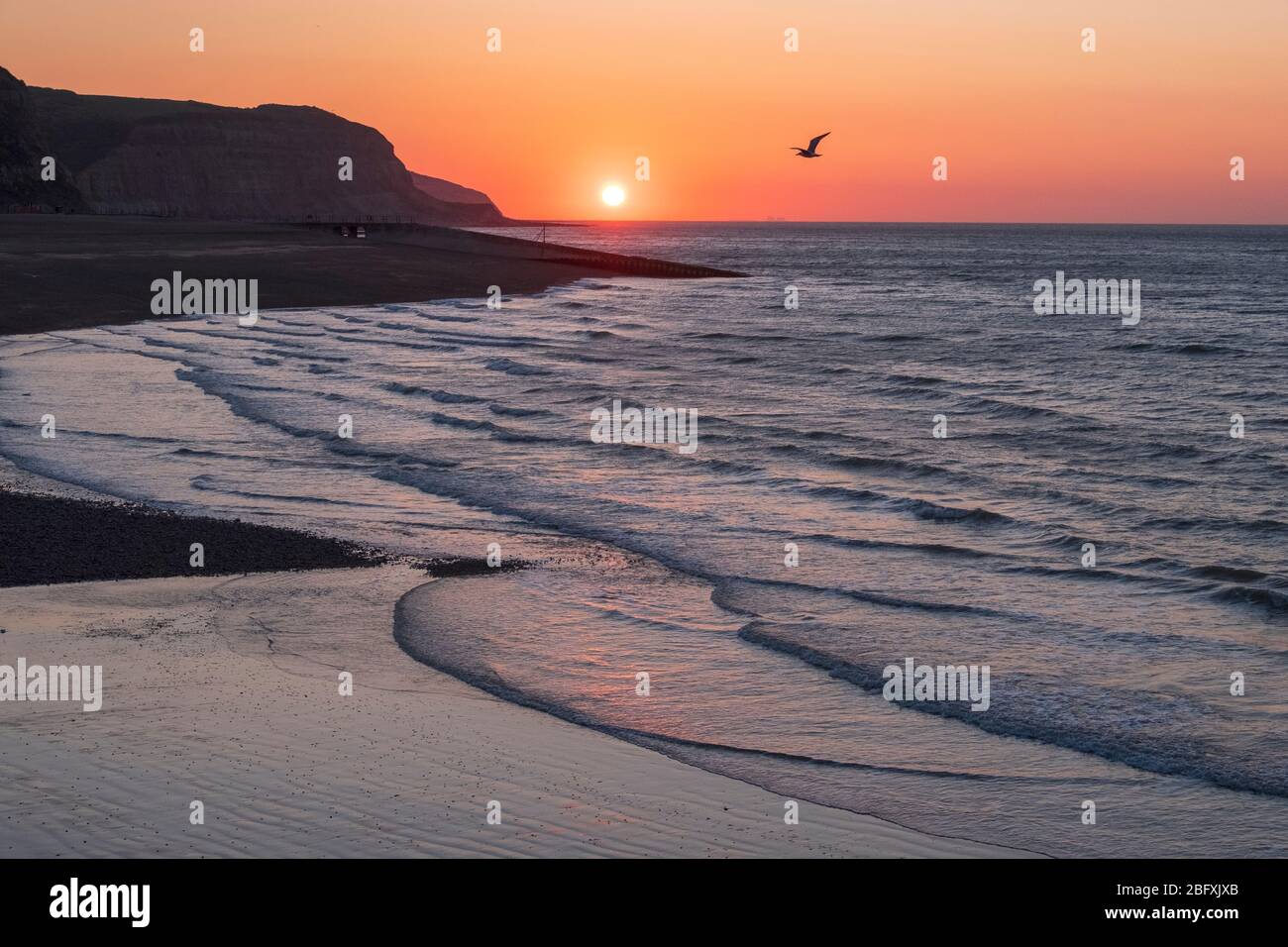 Hastings, East Sussex, 20th April 2020. Clear sunrise at low tide at the harbour on a chilly morning, but with another fine sunny day in prospect. Carolyn Clarke/Alamy Live News Stock Photo