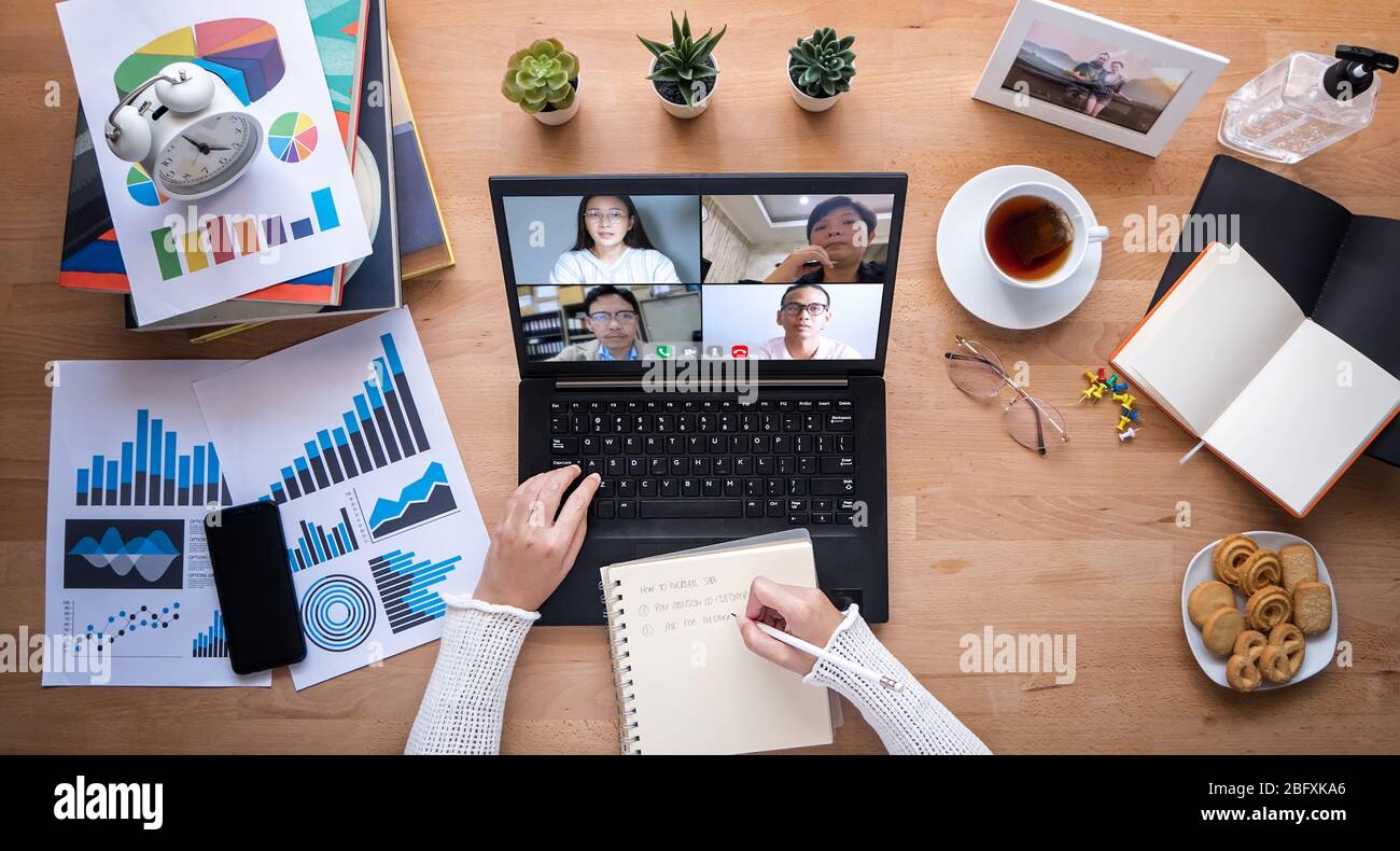 work from home. people making video conference with colleague via laptop computer during home quarantine to avoid spreading illness transmission of CO Stock Photo