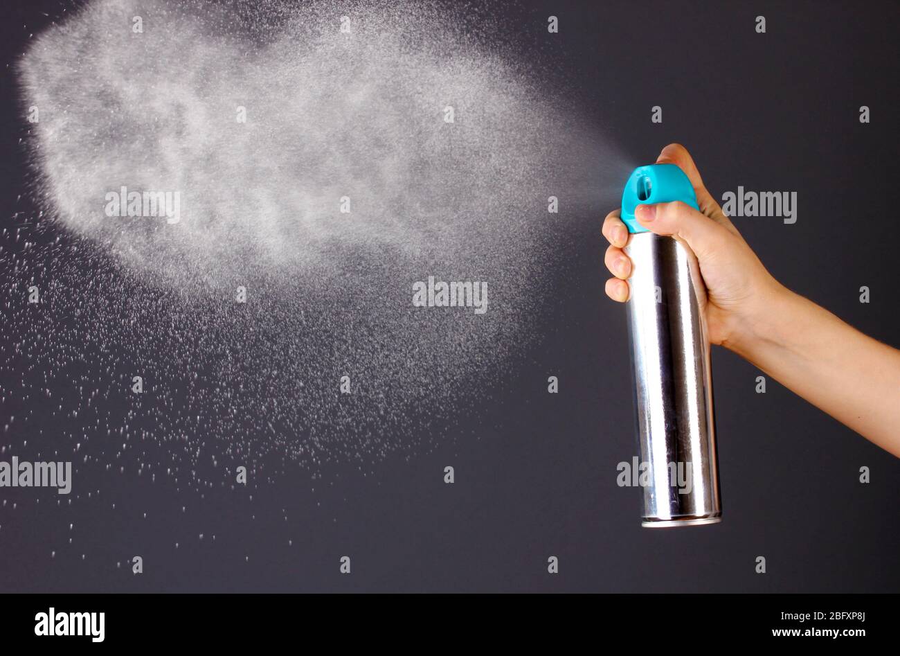 Sprayed air freshener in hand on grey background Stock Photo Alamy