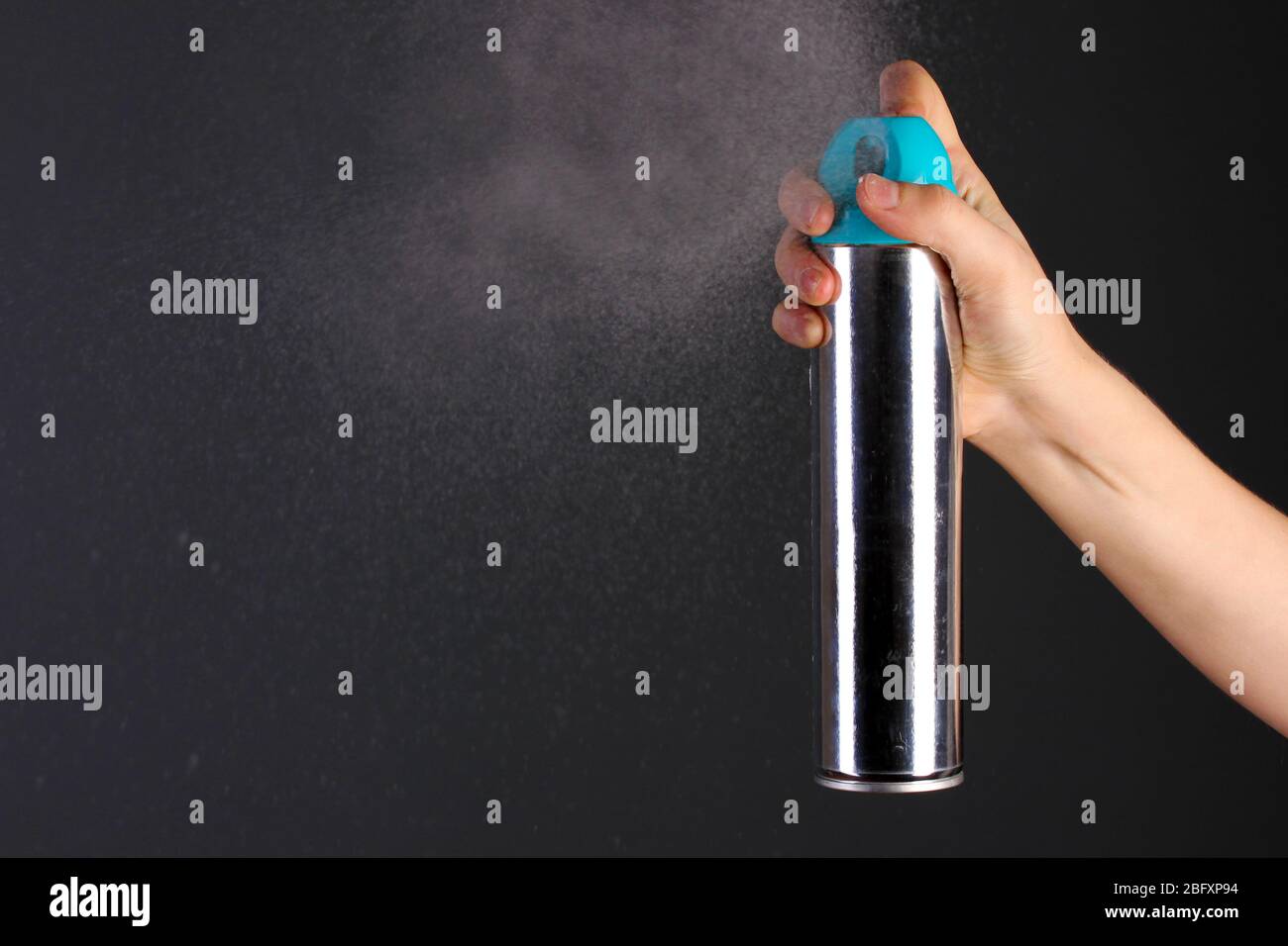 Sprayed air freshener in hand on grey background Stock Photo Alamy