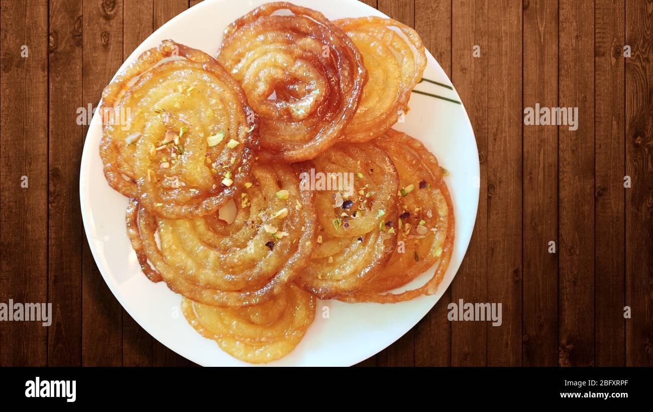 Home Made Jalebi - An Indian Sweet on Wooden Table Stock Photo