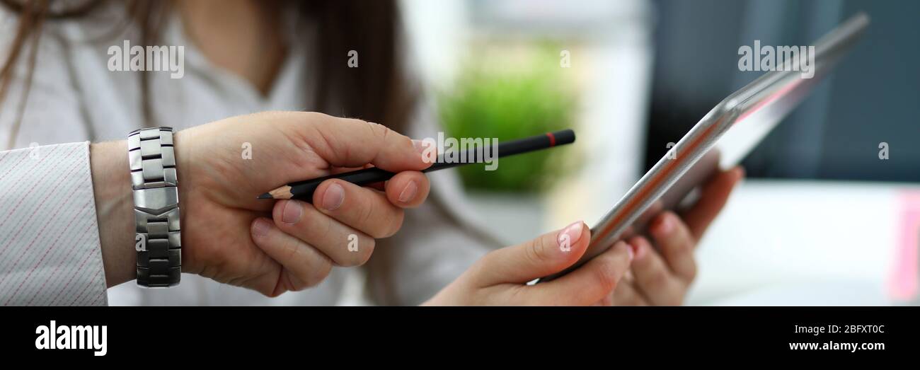 Two architects discussing drawing together using tablet pc Stock Photo