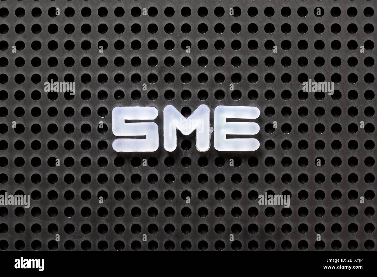 Black color pegboard with white letter in word SME (abbreviation of