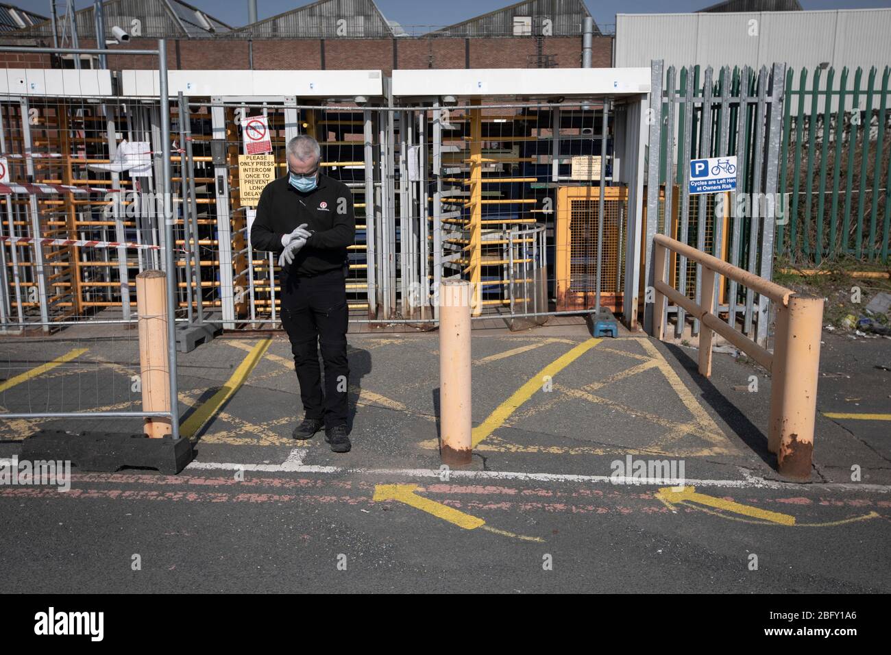 A member of staff at the redesigned workers' entrance at the Vauxhall car factory during preparedness tests and redesign ahead of re-opening following the COVID-19 outbreak. Located in Ellesmere Port, Wirral, the factory opened in 1962 and currently employs around 1100 workers. It ceased production on 17 March 2020 and will only resume work upon the advice of the UK Government, which will involve stringent physical distancing measures being in place across the site. Stock Photo