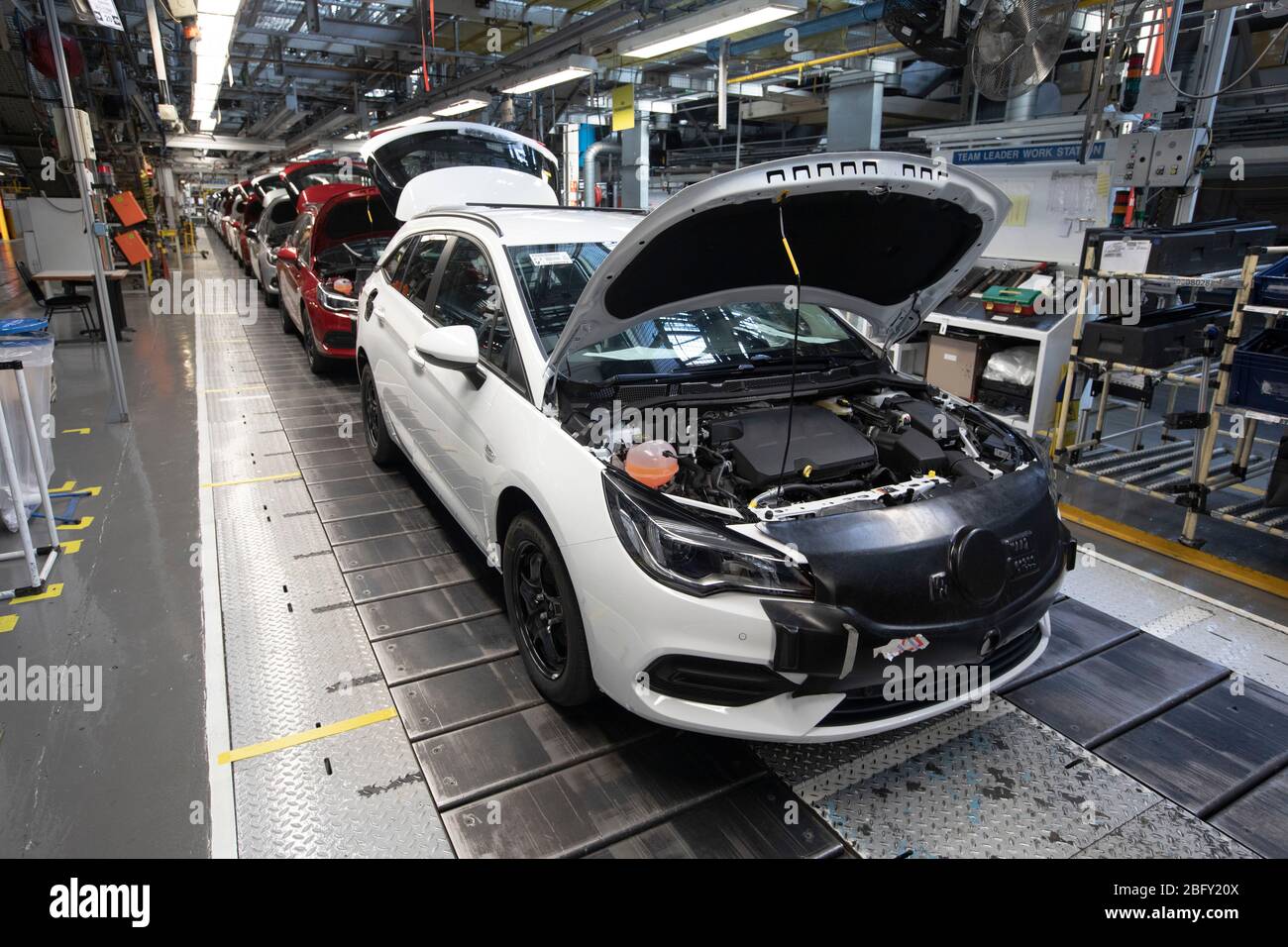 A line of cars on a car assembly line at the Vauxhall car factory during preparedness tests and redesign ahead of re-opening following the COVID-19 outbreak. Located in Ellesmere Port, Wirral, the factory opened in 1962 and currently employs around 1100 workers. It ceased production on 17 March 2020 and will only resume work upon the advice of the UK Government, which will involve stringent physical distancing measures being in place across the site. Stock Photo