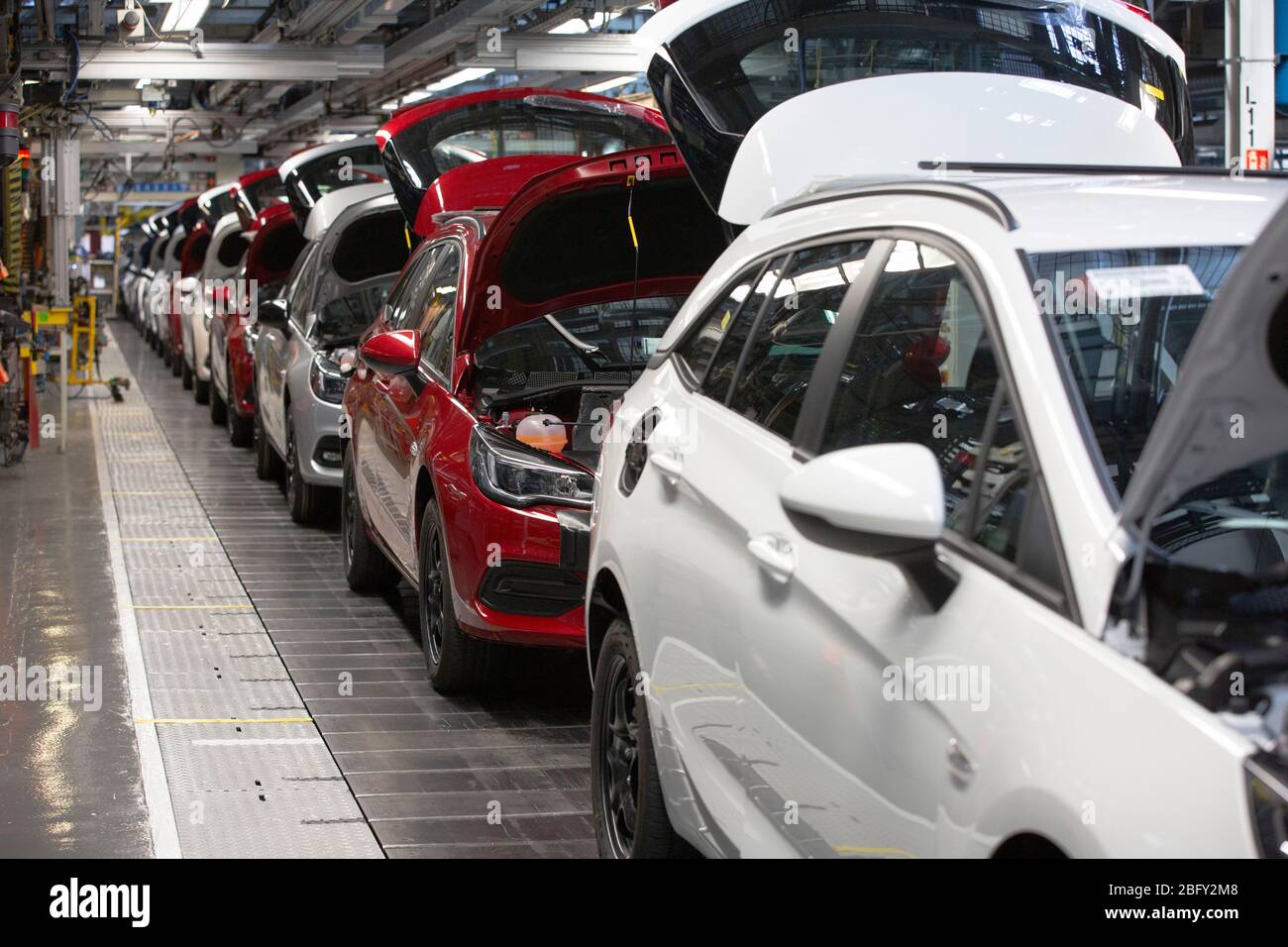 A line of cars on a car assembly line at the Vauxhall car factory during preparedness tests and redesign ahead of re-opening following the COVID-19 outbreak. Located in Ellesmere Port, Wirral, the factory opened in 1962 and currently employs around 1100 workers. It ceased production on 17 March 2020 and will only resume work upon the advice of the UK Government, which will involve stringent physical distancing measures being in place across the site. Stock Photo