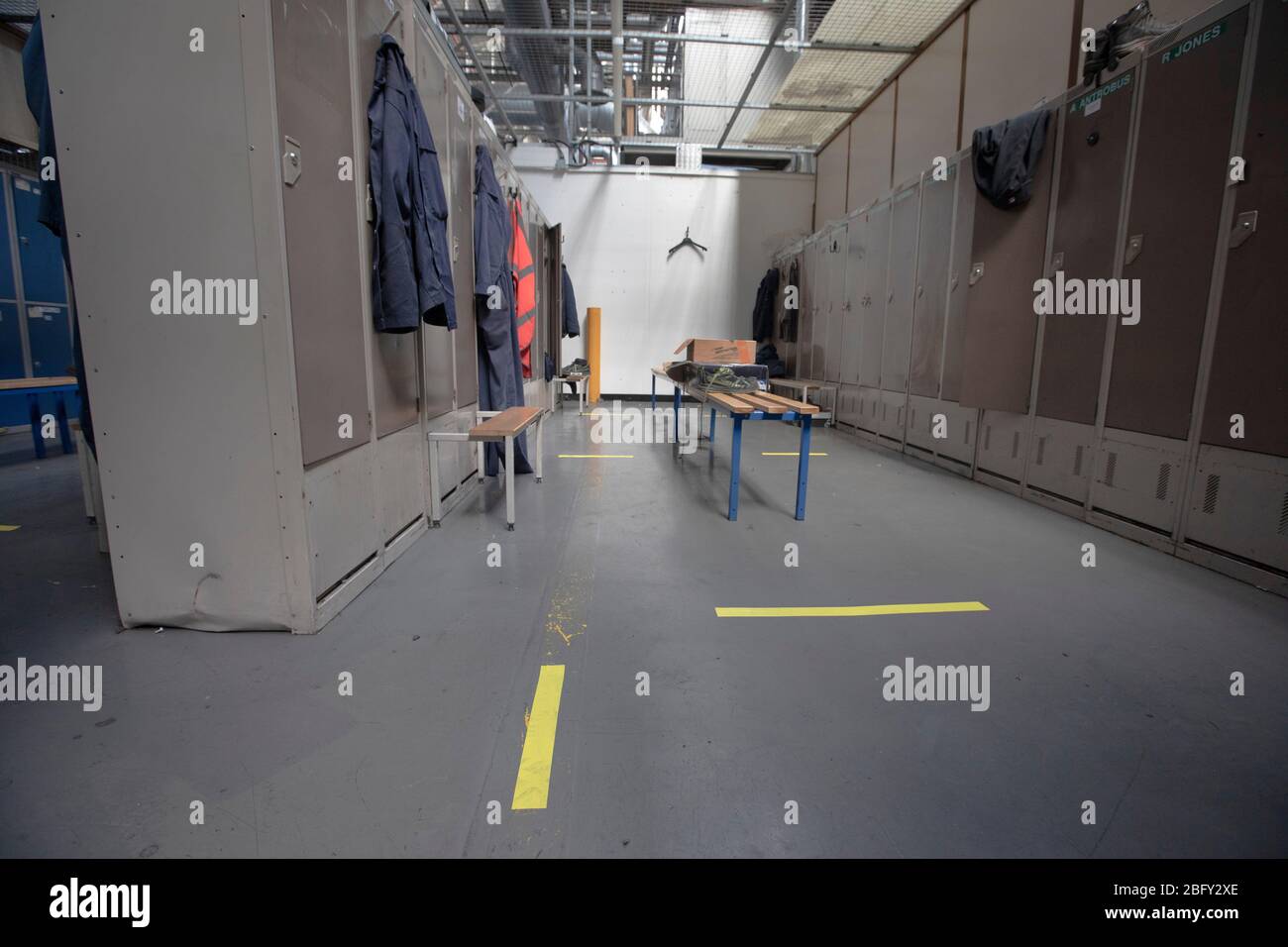 A workers locker room with floor markings at the Vauxhall car factory photographed undergoing preparedness tests and redesign ahead of re-opening following the COVID-19 outbreak. Located in Ellesmere Port, Wirral, the factory opened in 1962 and currently employs around 1100 workers. It ceased production on 17 March 2020 and will only resume work upon the advice of the UK Government, which will involve stringent physical distancing measures being in place across the site. Stock Photo