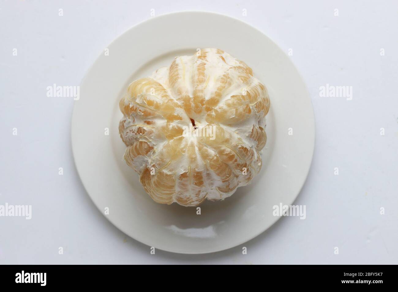 Freshly peeled Pomelo or known as Citrus maxima, Citrus grandis isolated on white background Stock Photo