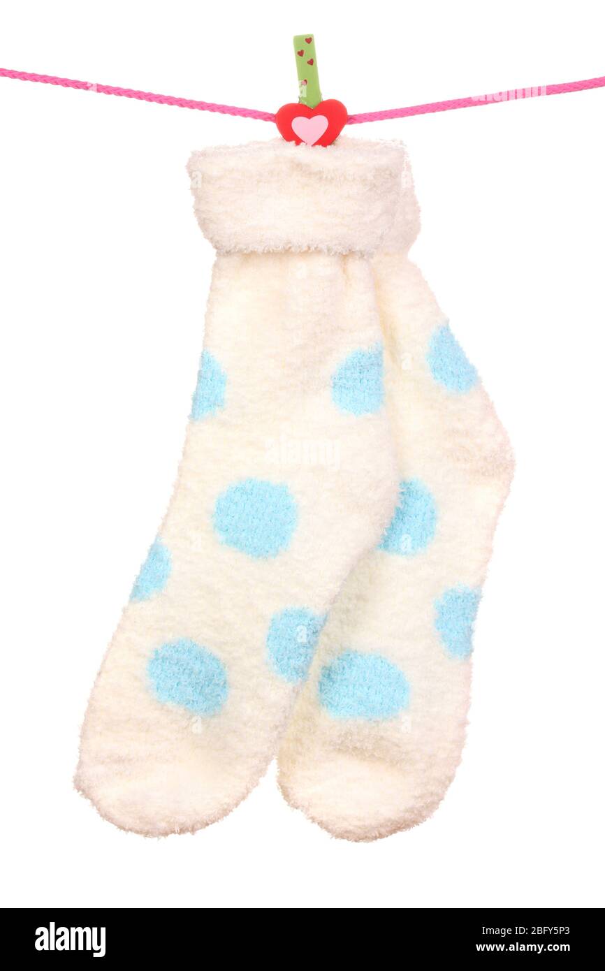 Pair of socks with polka dots hanging on a rope isolated on white Stock ...