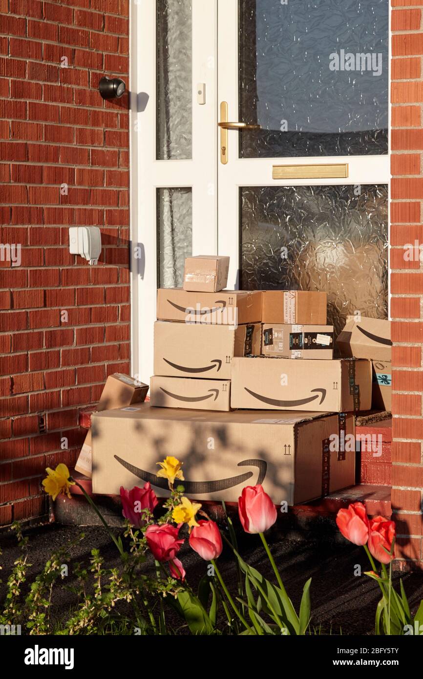 large consignment of amazon deliveries left on doorstep of house during coronavirus covid-19 lockdown in the uk Stock Photo