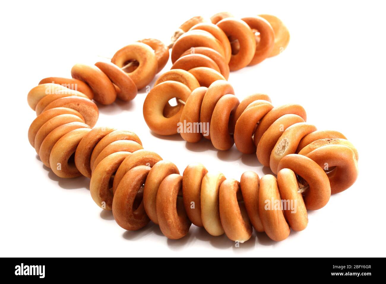tasty bagels on rope, isolated on white Stock Photo - Alamy