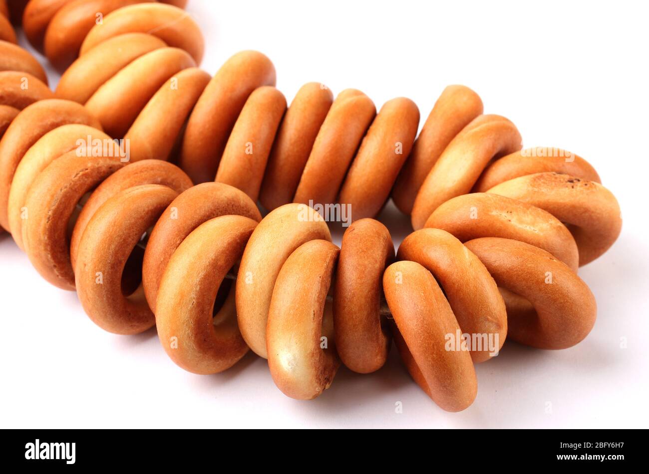 tasty bagels on rope, isolated on white Stock Photo - Alamy