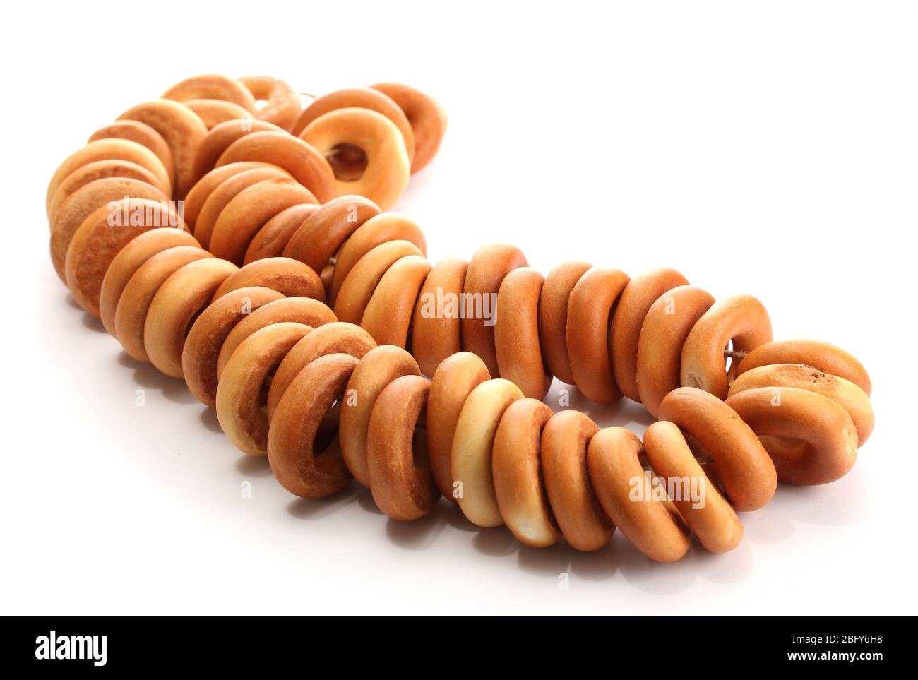 tasty bagels on rope, isolated on white Stock Photo - Alamy