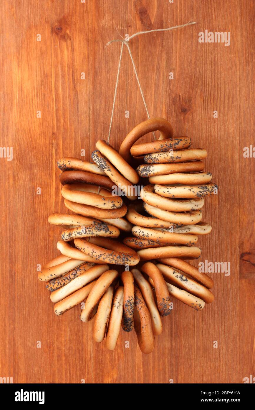 tasty bagels on rope, on wooden background Stock Photo - Alamy