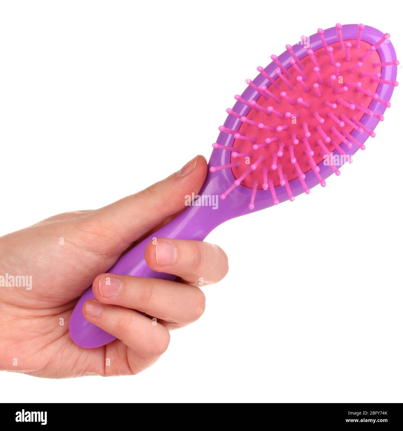 purple hair brush in the hand isolated on white Stock Photo - Alamy