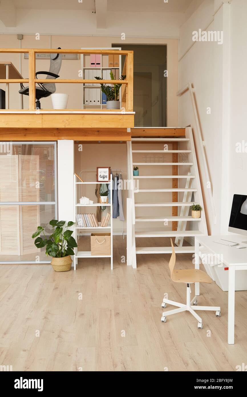 Vertical background image of modern two level office interior with minimal design and wooden details, copy space Stock Photo