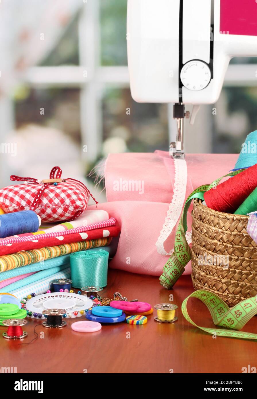 sewing machine and fabric on bright background Stock Photo Alamy